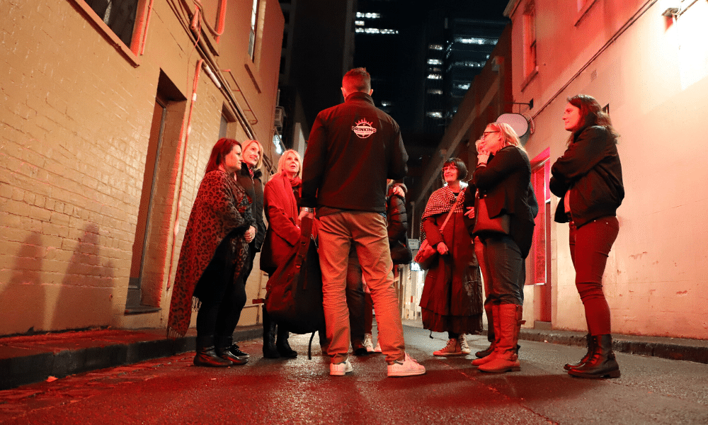A picture of a Drinking History Tour group in the old red light district of Melbourne.