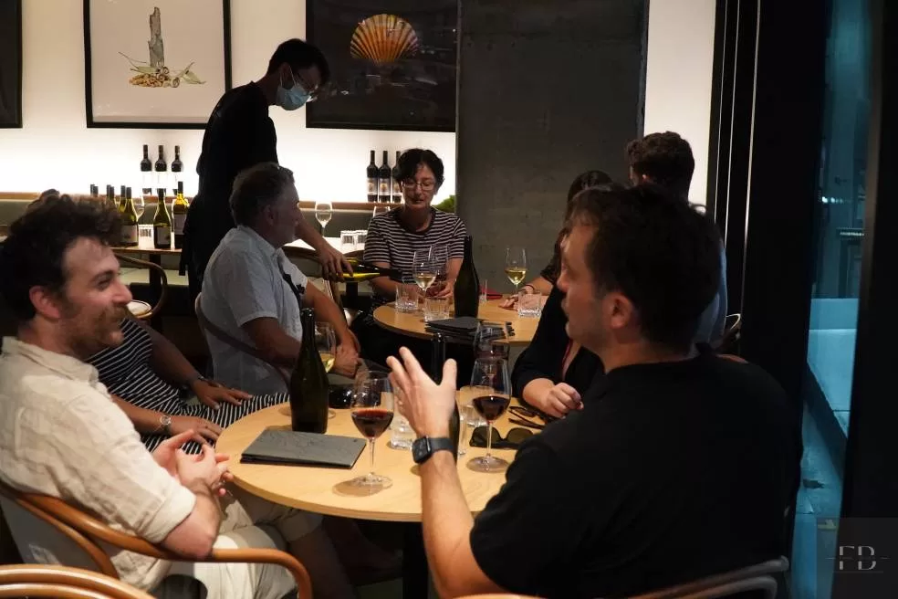 A group of people enjoying a wine in a bar