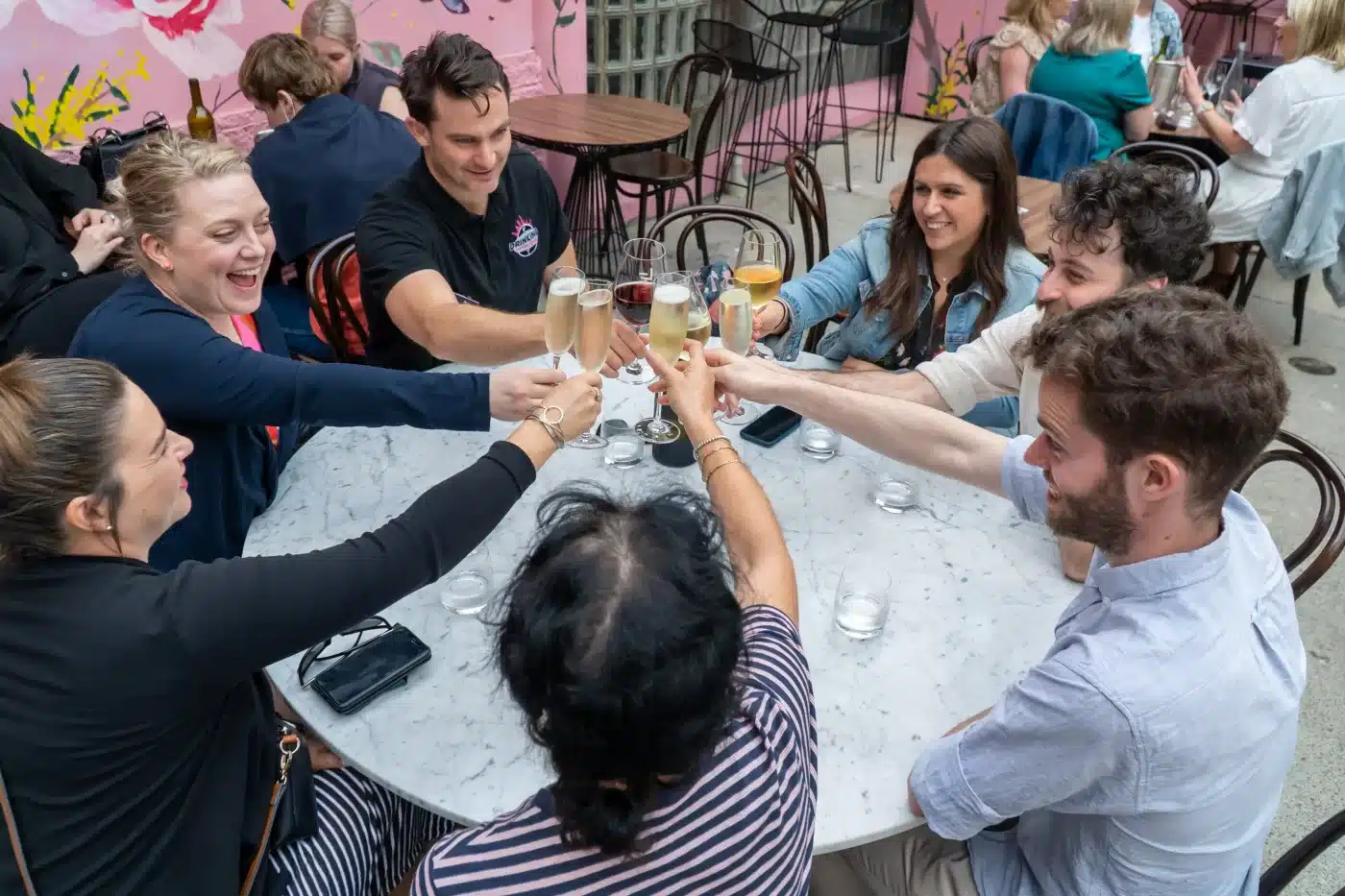 A picture of a group of people enjoying a glass of wine at a laneway wine bar in Melbourne
